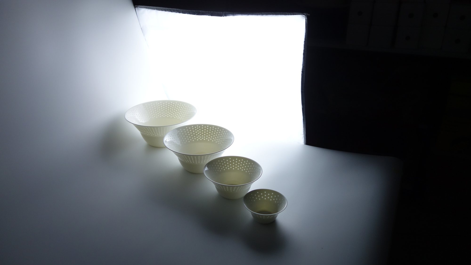 Four Bowling Bowls in descending size, lit from behind