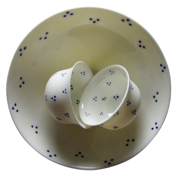 A pierced Planet Bowl seen from above, holding two small cups